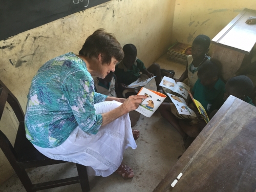 Joan reading to school children in Ghana
