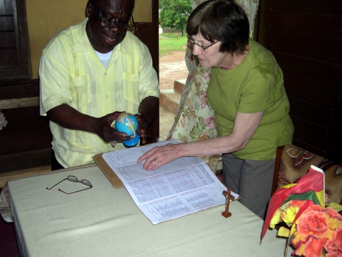 Joan and Monsignor Francis Tawiah discuss school needs in Takoradi.